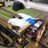 Securing the instrument to the bench to work on the fingerboard removal