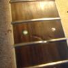 There is also damage to the surrounding fretboard that must be filled in and leveled smooth.